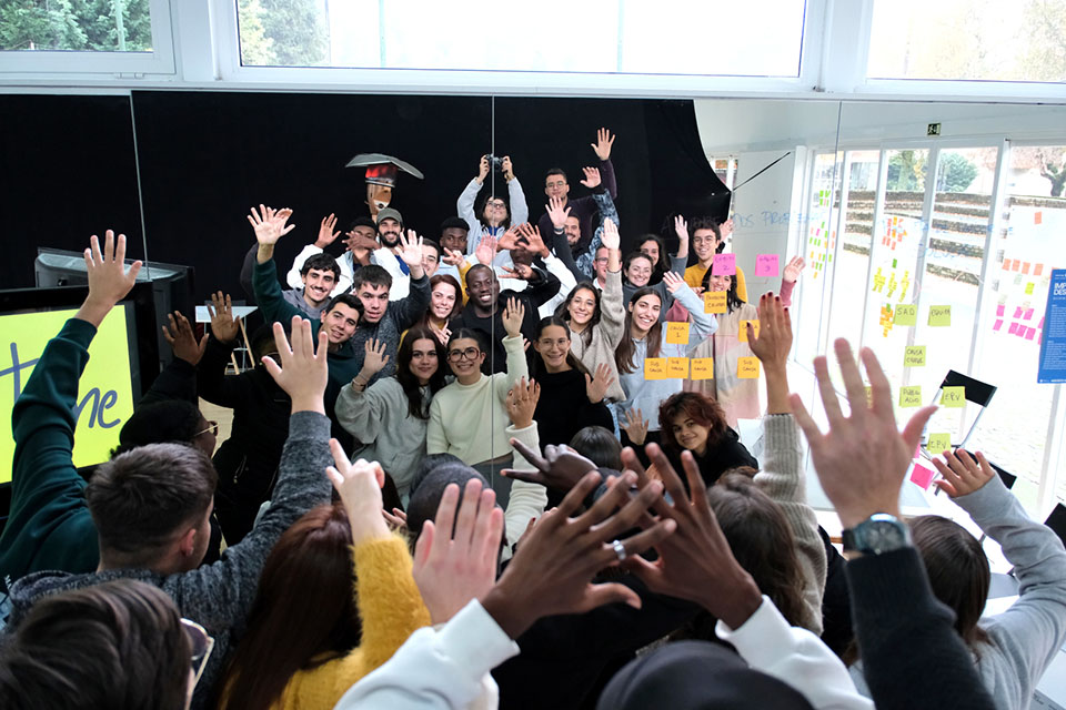 grupo de jovens com as mão no ar  refletidos em espelho