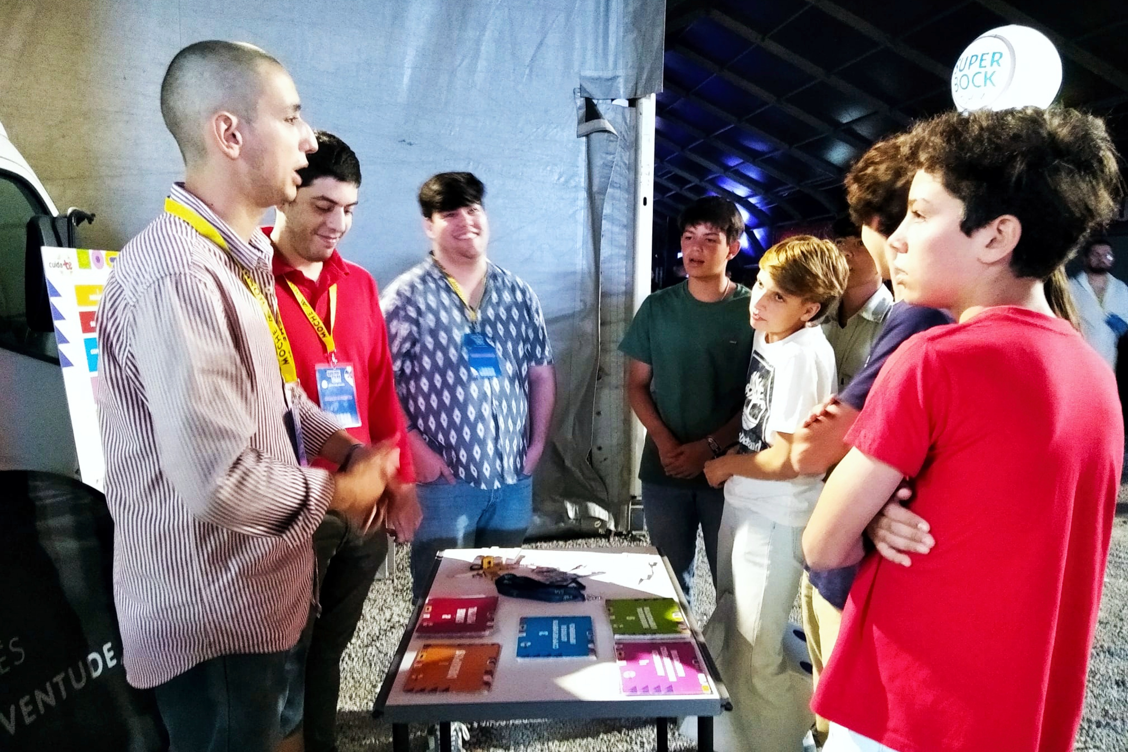 Voluntários João, Tiago e Ulisses, na dinamização do jogo Cuida-te+, junto de vários jovens.